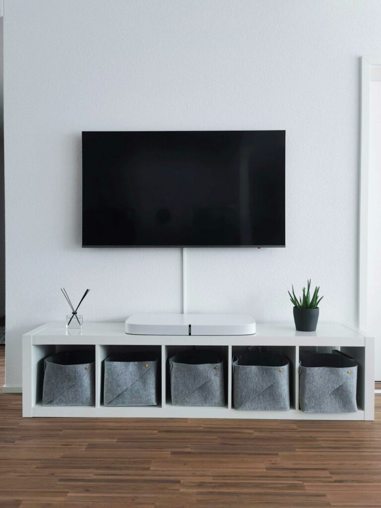 Modern bright living room with large windows and a TV